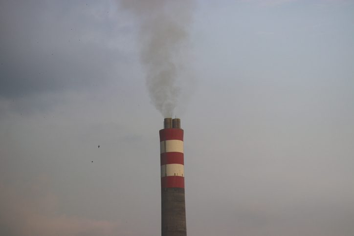 A tall smoke stack with red and white stripes.