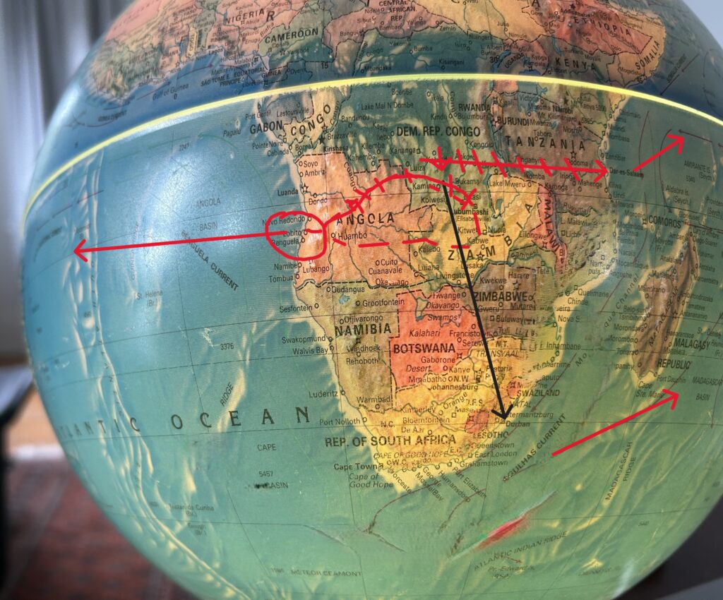 Globe with red arrows and markings.